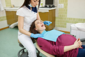 Pregnant woman receiving periodontal treatment